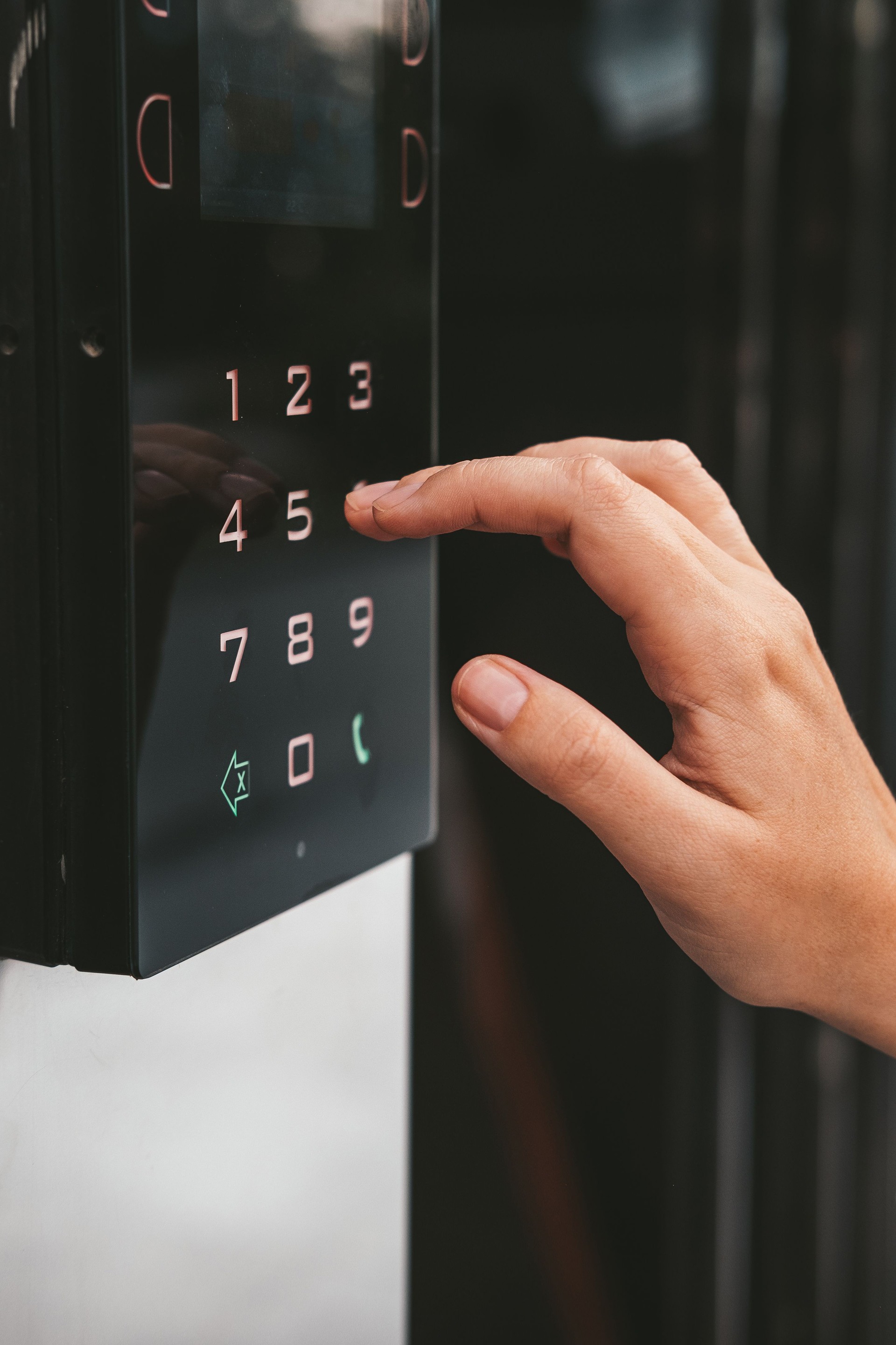 Entering a digital code on the control panel to enter the building.
